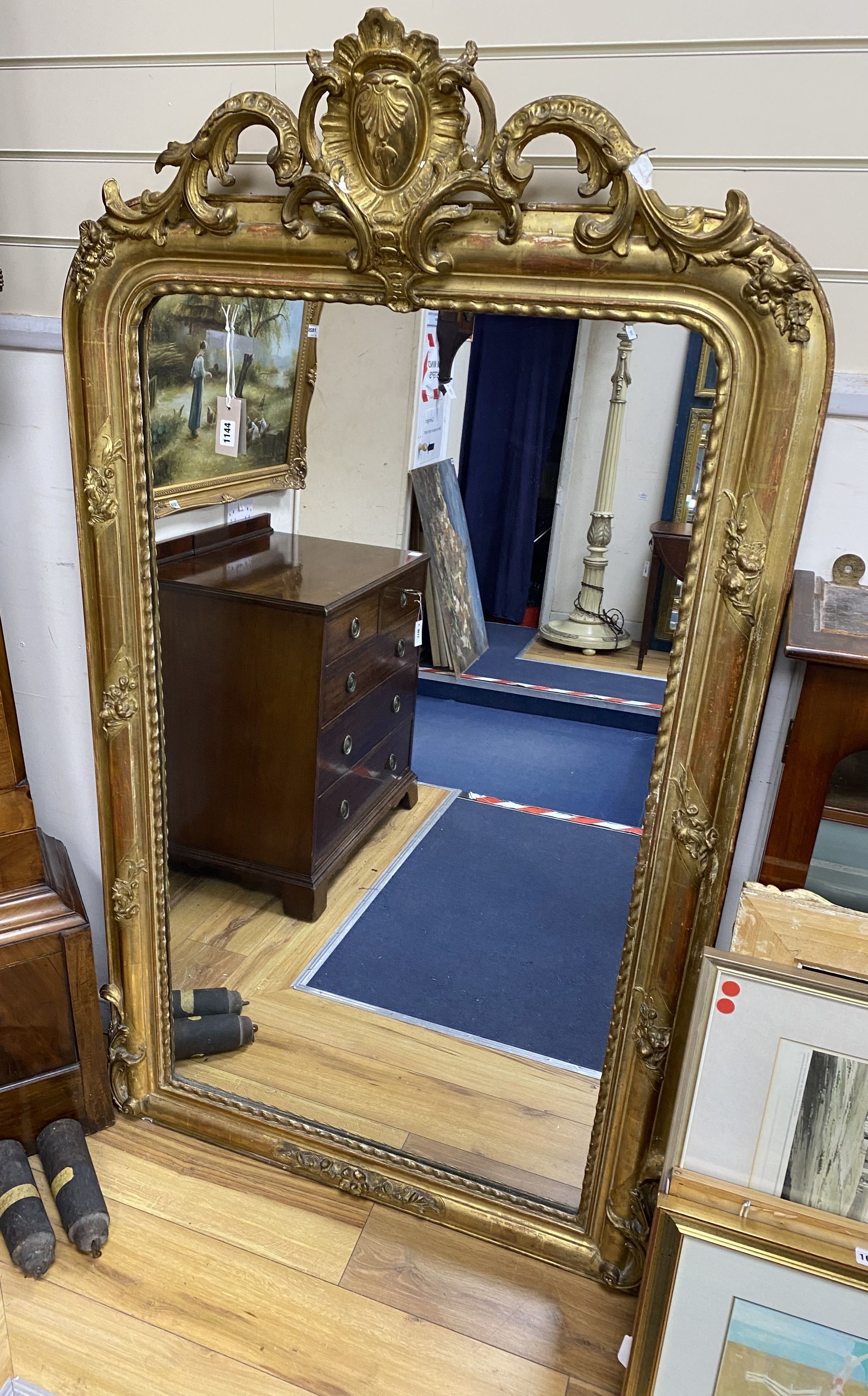 A 19th century French overmantel mirror, giltwood and gesso with channelled frame and scroll with cabochon crest detail, width 98cm, height 164cm